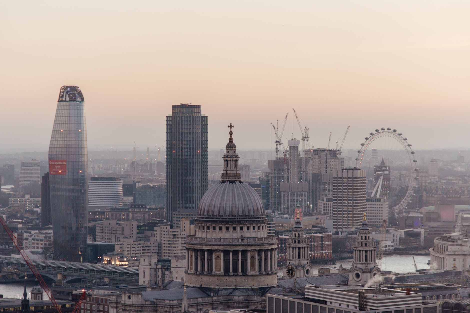 cityscape with cathedral and ferris wheel in london