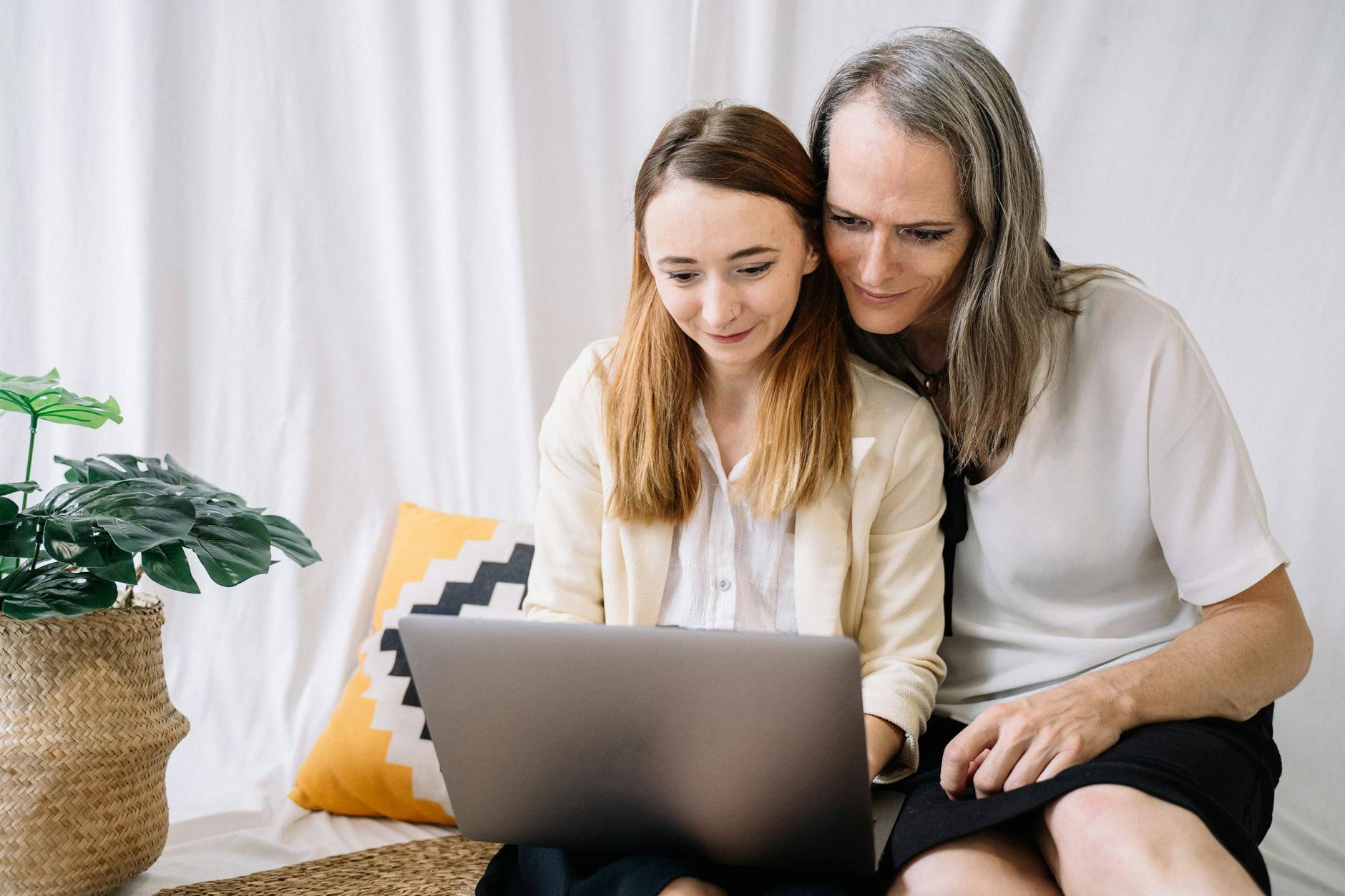 an image of a couple staring at a laptop